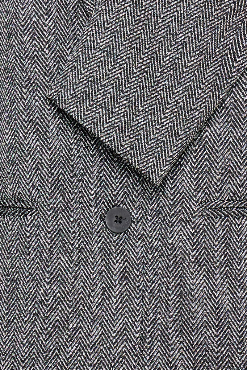Tailleur spigato con giacca oversize e pantalone palazzo