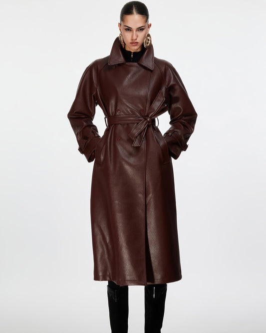 Long burgundy faux leather trench coat with hammered effect, buttons and removable belt at the waist
